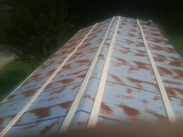 Rusted metal roof panels with new wood purlins before replacement — Storm Damage Roof Repair in Olivehurst by Roofing Brothers