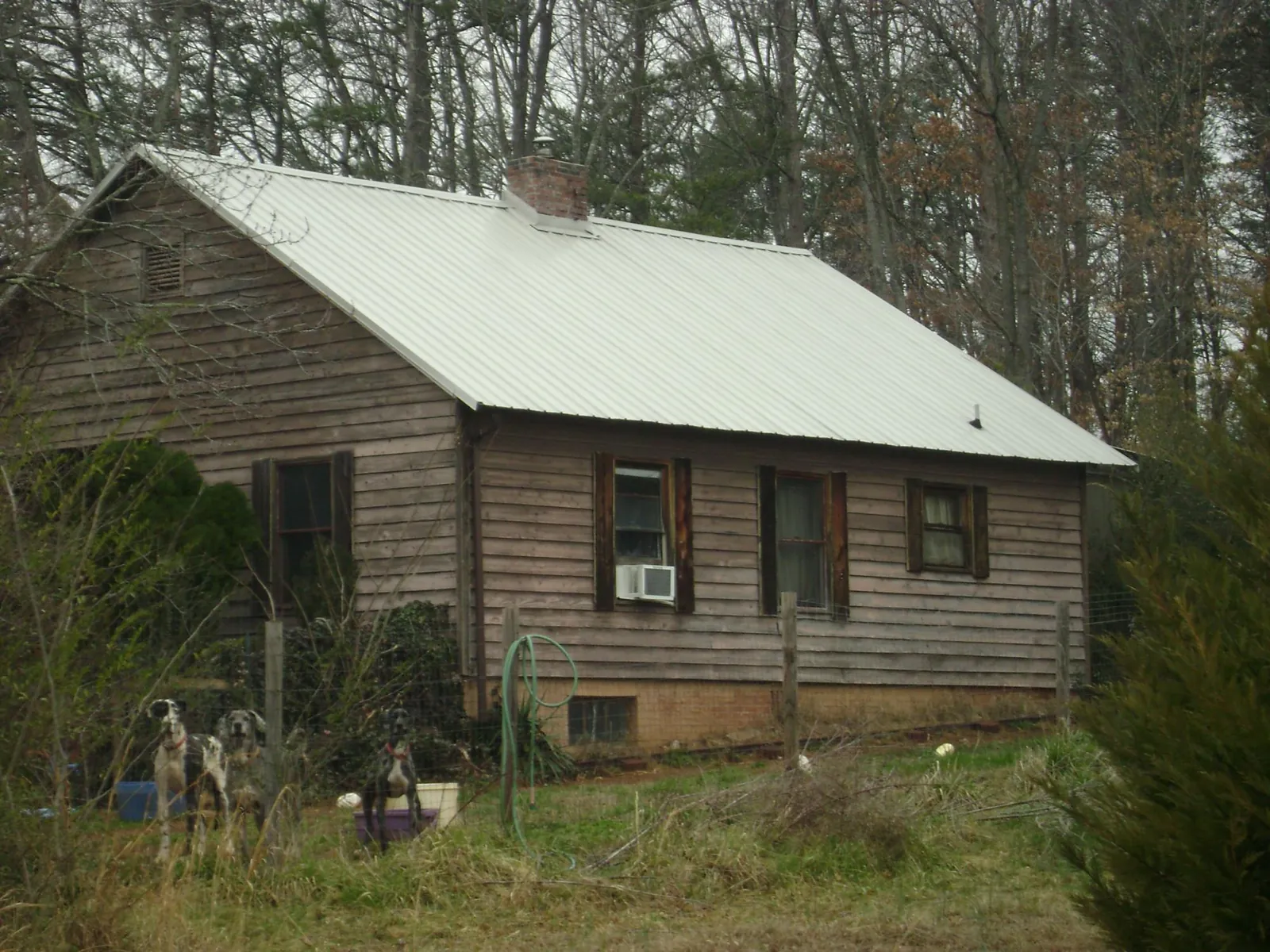 White metal roof on an old wood sided farmhouse, from a Metal Roof Installation job in Olivehurst